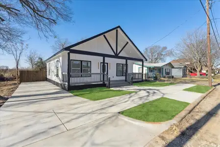 View of front of home with a front lawn, fence, a porch, and concrete driveway