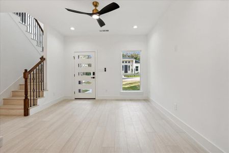 Entrance foyer with light wood-type flooring and ceiling fan