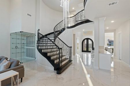 Entryway with a towering ceiling and french doors