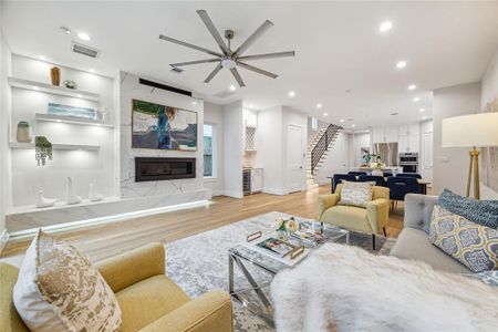 First floor living room with gas fireplace, custom shelving and dedicated bar area with wine/beverage cooler. (Similar floor plan)