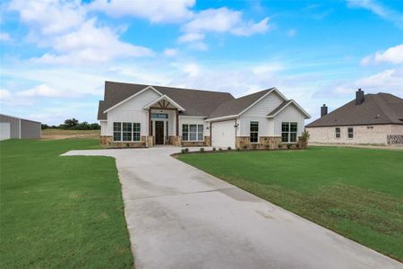 View of front of property with a garage and a front yard