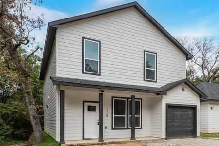 View of front of property with a garage and covered porch