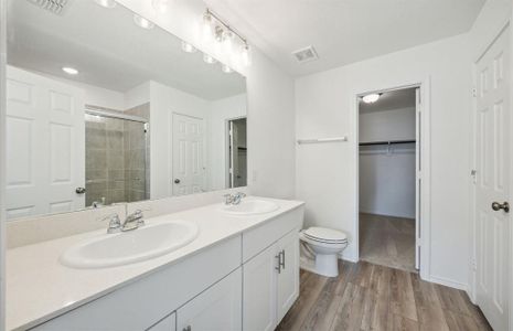 Elegant owner's bath with dual vanity *real home pictured