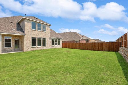 Rear view of house featuring a lawn