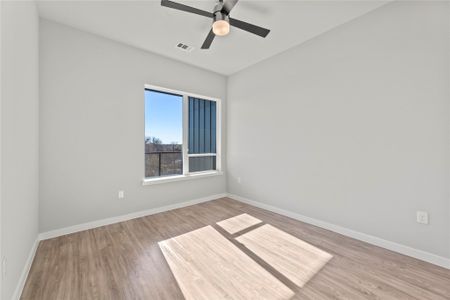 Spare room with ceiling fan and light wood-type flooring