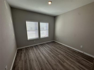 Unfurnished room with dark hardwood / wood-style flooring