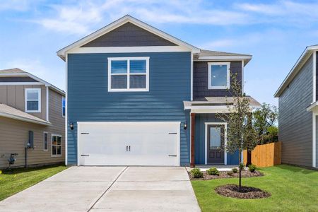 View of front of house featuring a garage and a front lawn