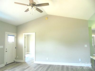 Vaulted Living room- LVP flooring through out this small home with upper end finishes!