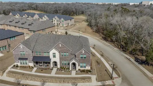 Drone / aerial view featuring a wooded view and a residential view