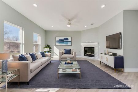 Living room featuring ceiling fan and light hardwood / wood-style floors