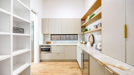 Kitchen featuring stainless steel oven, beverage cooler, light hardwood / wood-style floors, backsplash, and light stone counters