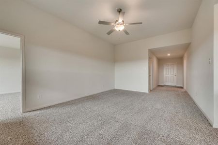 Carpeted empty room with ceiling fan