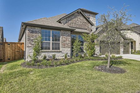 View of front of home featuring a front yard and a garage