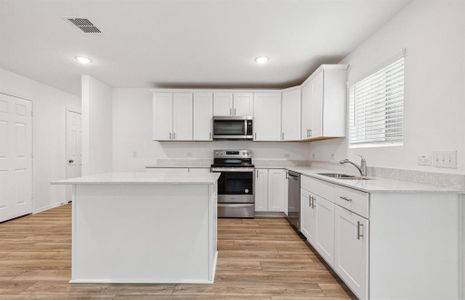 Kitchen featuring a large island ideal for informal dining and gatherings *Real home pictured