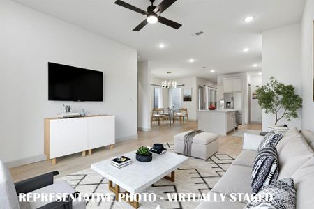 With the family room open to the kitchen and dining areas, this open concept home was made for entertaining!  REPRESENTATIVE PHOTO VIRTUALLY STAGED