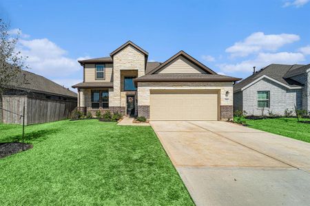 Discover this stunning modern two-story home with a charming stone and brick exterior, a spacious two-car garage, and beautifully landscaped front yard.