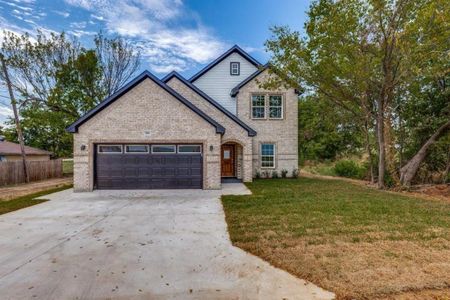 View of front of property with a front lawn and a garage