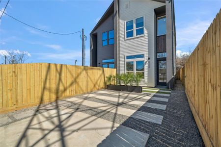 This fully-gated front courtyard features a double-wide driveway and beautiful landscaping.