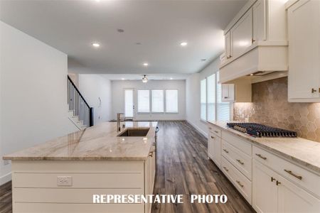 Open to the living and dining rooms, entertaining is a breeze in this great home!  REPRESENTATIVE PHOTO.