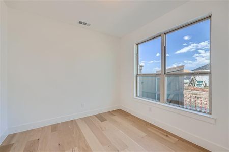 Spare room with plenty of natural light and light hardwood / wood-style floors