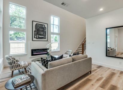 Living room with light wood-type flooring and a healthy amount of sunlight