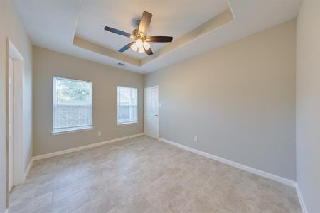 The master bedroom is a spacious retreat with tile floors and a vaulted ceiling, offering both luxury and comfort. The high ceiling creates an airy, open feel, while the sleek tile floors are stylish and easy to maintain—perfect for unwinding after a long day.