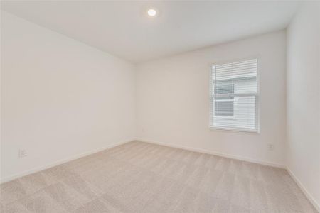 Empty room with light colored carpet