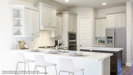 Kitchen with decorative backsplash, a peninsula, dark wood finished floors, and a center island