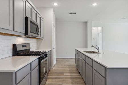 Kitchen in the Heisman home plan by Trophy Signature Homes – REPRESENTATIVE PHOTO