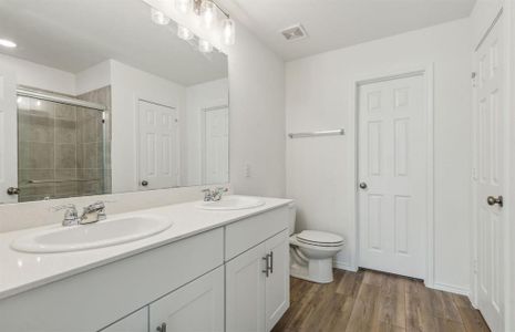 Spacious owner's bathroom with dual vanity *real home pictured