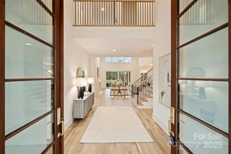 Step through the covered brick portico and enter the home through these handcrafted arched front doors made of solid Sapele wood.