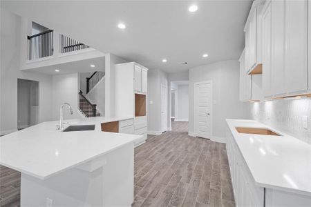 This kitchen is by far any chef’s dream! This spacious kitchen features high ceilings, white stained wood cabinets, quartz countertops, SS appliances, modern tile backsplash, recessed lighting, extended counter space, extra space for breakfast bar, and a walk-in pantry all overlooking your huge family room.