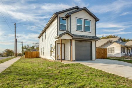 View of front facade with a garage and a front lawn