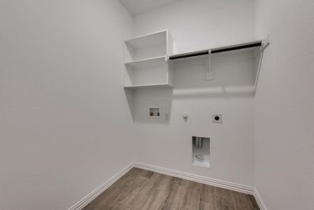 Laundry room featuring gas dryer hookup, hookup for a washing machine, hookup for an electric dryer, and hardwood / wood-style flooring