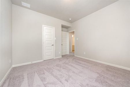 Unfurnished room with light carpet