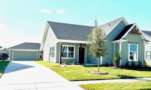 View of front of property with a garage and a front yard