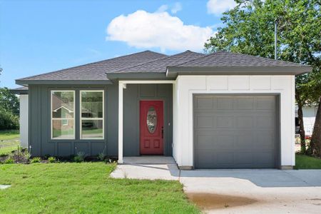 View of front of house with a garage and a front lawn