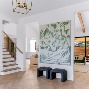 Corridor with a notable chandelier, lofted ceiling with beams, and plenty of natural light