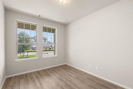 The home office features beautiful floors, large windows that give a fresh feel, this space promotes focus and creativity.