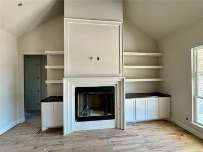 Beautiful fireplace in vaulted ceiling living room with wood beams