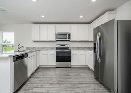 The kitchen is chef-ready with stainless steel appliances