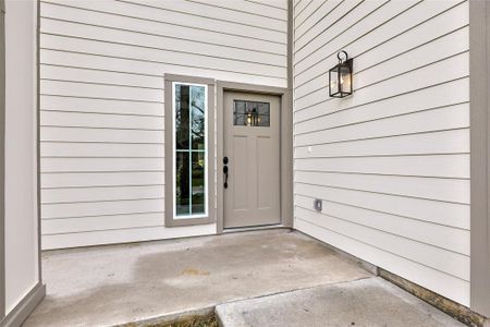 Welcoming front porch with soaring high ceiling.