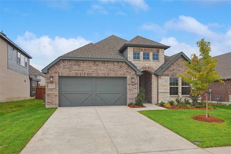 View of front facade with a garage and a front yard