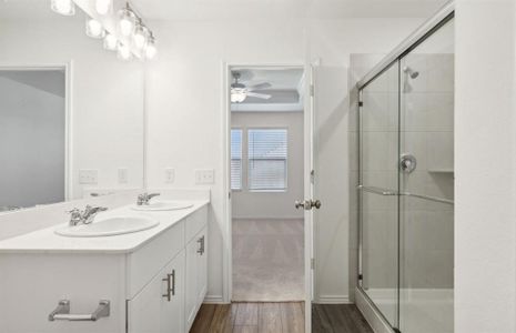 Spacious owner's bathroom with dual vanity and oversized shower*real home pictured