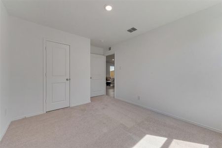 Unfurnished bedroom featuring light colored carpet