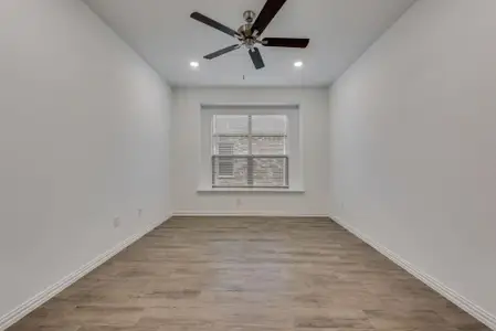 Spare room featuring ceiling fan and light wood-type flooring