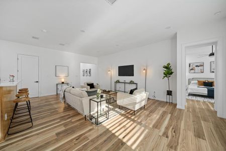 Living room with french doors, hardwood / wood-style flooring, and plenty of natural light