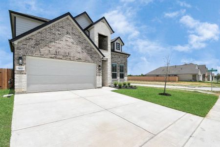 The residence features a practical 2-car garage complemented by a generous driveway, ensuring abundant space for parking needs.