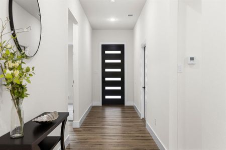 Doorway to outside with dark hardwood / wood-style flooring