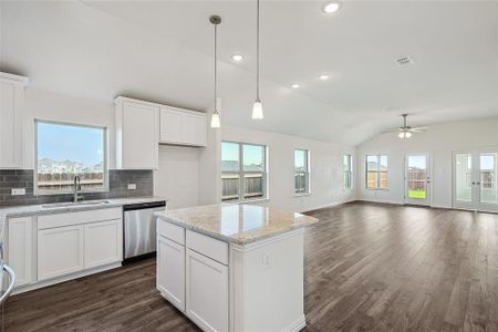 Kitchen with stainless steel dishwasher, ceiling fan, and white cabinets